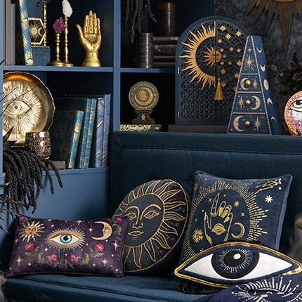 Mystical-themed home decor featuring dark blue and gold accents with celestial and occult motifs. 
