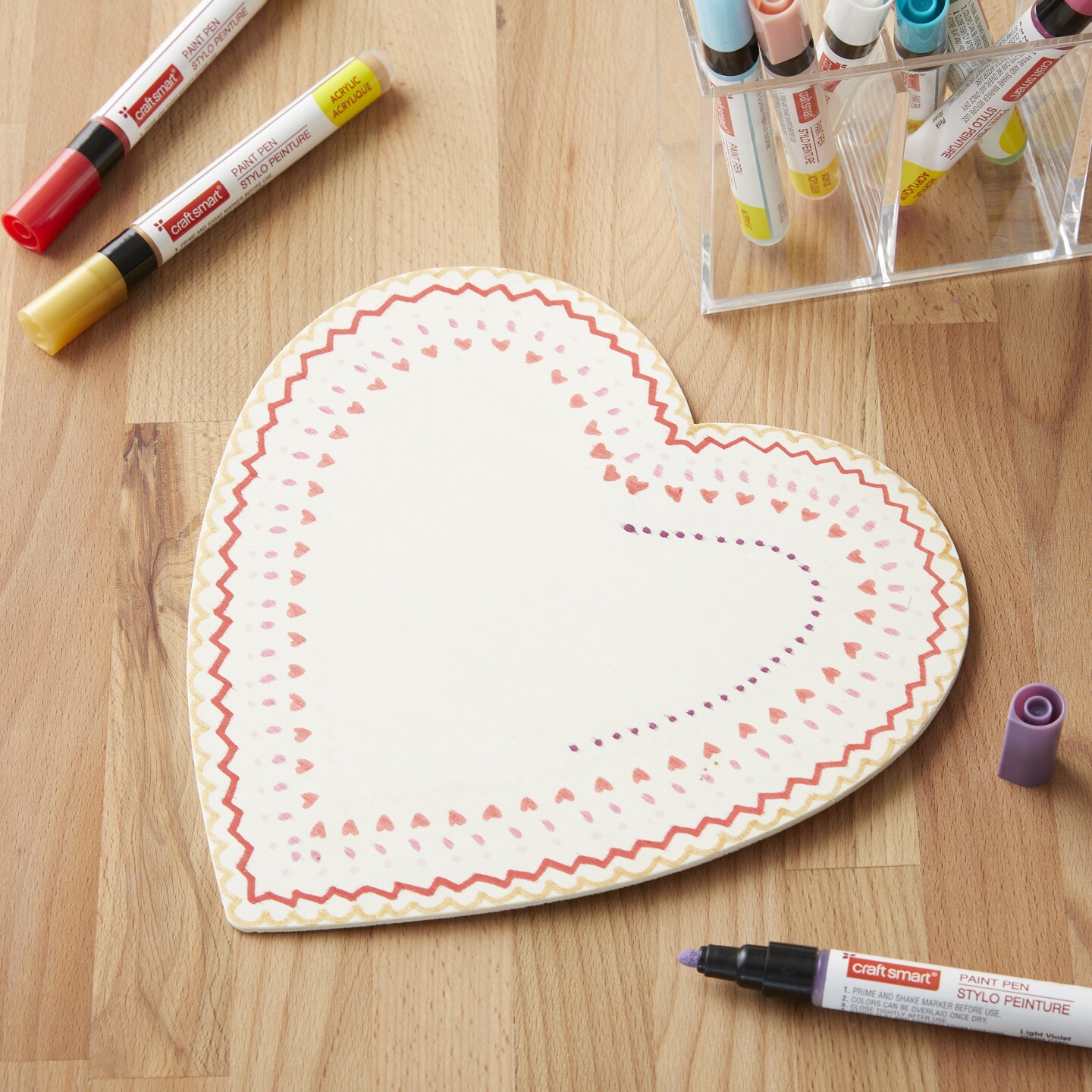 wooden heart with pattern made by paint pens
