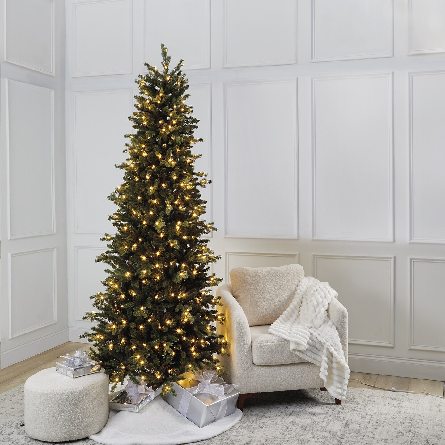 A christmas tree with lights and presents in a room