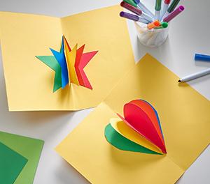 Star and heart multi-colored construction paper craft on a white table