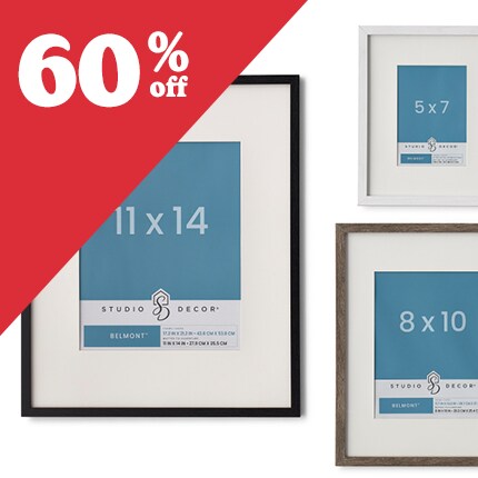 two brown wood and one white wood frames with white matts