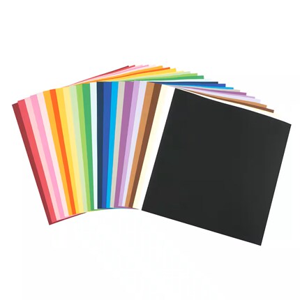 Fan of colorful paper swatches spreads across a white background beside a large black sheet, showcasing a vibrant creative palette.