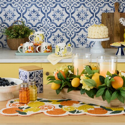 orange and lemon mugs, centerpiece and table runner in blue and white kitchen