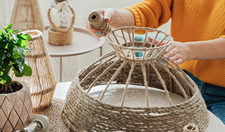 A woman's arms making a lampshade.