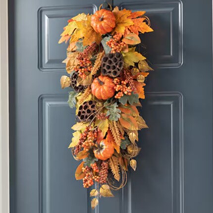 A door with a swag and pumpkins
