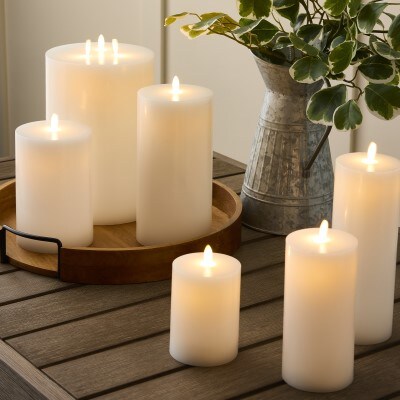 multiple pillar led flameless candles sitting on table 
