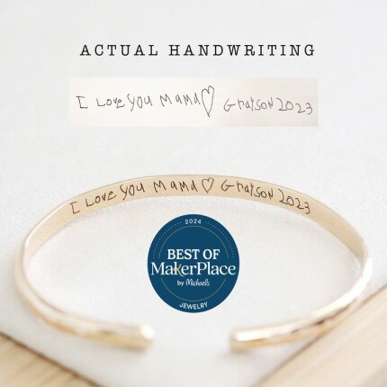 MakerPlace by Michaels Chic Mama Jewelry 14K gold-filled charm bracelet with heart, initial "M," bow, and gemstone charms. Features elegant text: "Non Tarnish + Waterproof" on beige background.