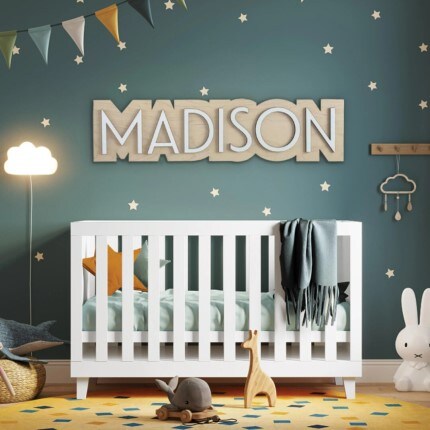 custom sign "MADISON" by Jaxley above a baby crib