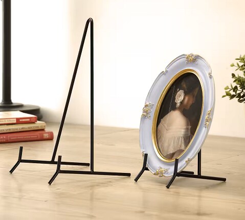 two black frame stands, one with small plate