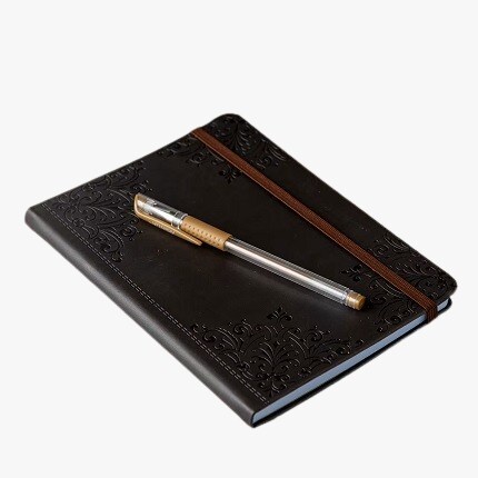brown leather journal with pen