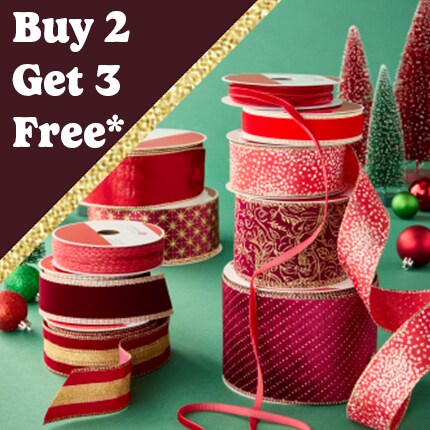 stacked spools of red decorative ribbon with buy 2 get 3 free in white text over red triangle