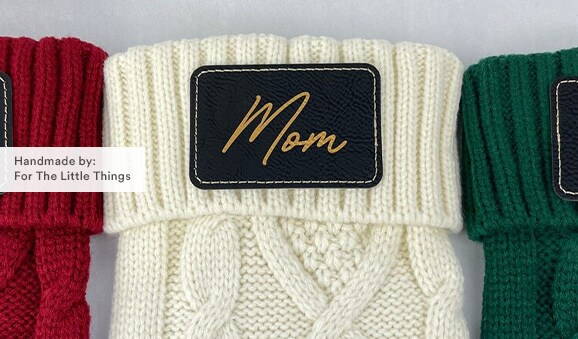 MakerPlace by Michaels custom knit Christmas stockings with Mya, Mom and Dad written on them