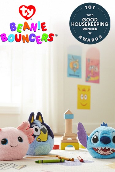 Five colorful Beanie Bouncer toys on a playroom floor with crayons and blocks. A "Good Housekeeping Toy Award 2025" badge is on the right.
