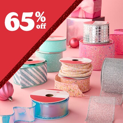 assorted pastel and metallic spools of ribbon with 65% off in white text in red triangle