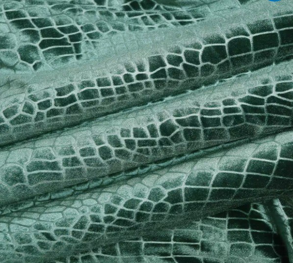 green fabric in velvet