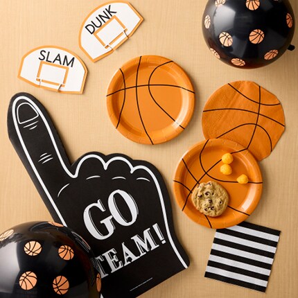 black balloons with basketballs, foam finger and basketball plates