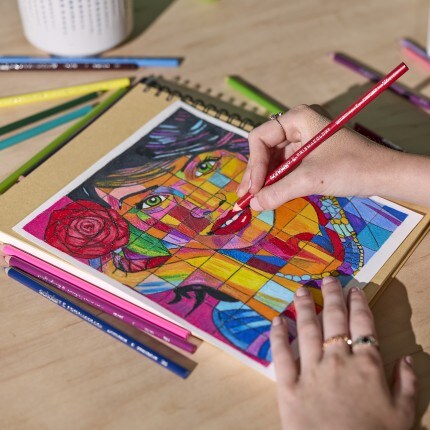 person using sharpie marker to draw on paper
