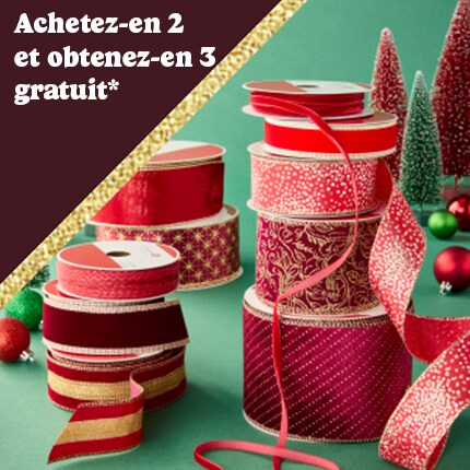 stacked spools of red decorative ribbon with buy 2 get 3 free in white text over red triangle