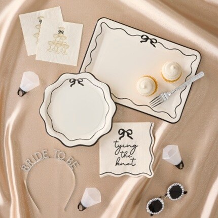 black and white bow party plates and napkins with bridal accessories