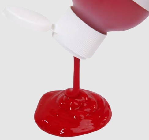 Red paint poured out of a bottle. 