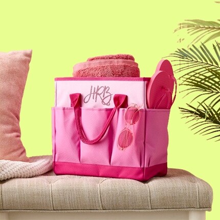 pink tote bag with flip flops and towel