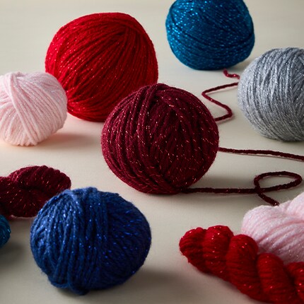 balls of Big Twist twinkle yarn in blues and reds