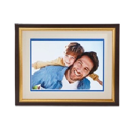 silver frame on tan wall with family photo