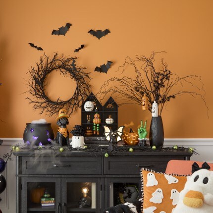Halloween Trick or Treat Decor Collection showing tabletop decorations in orange and black colors: ghosts, wreaths, bat, pumpkin
