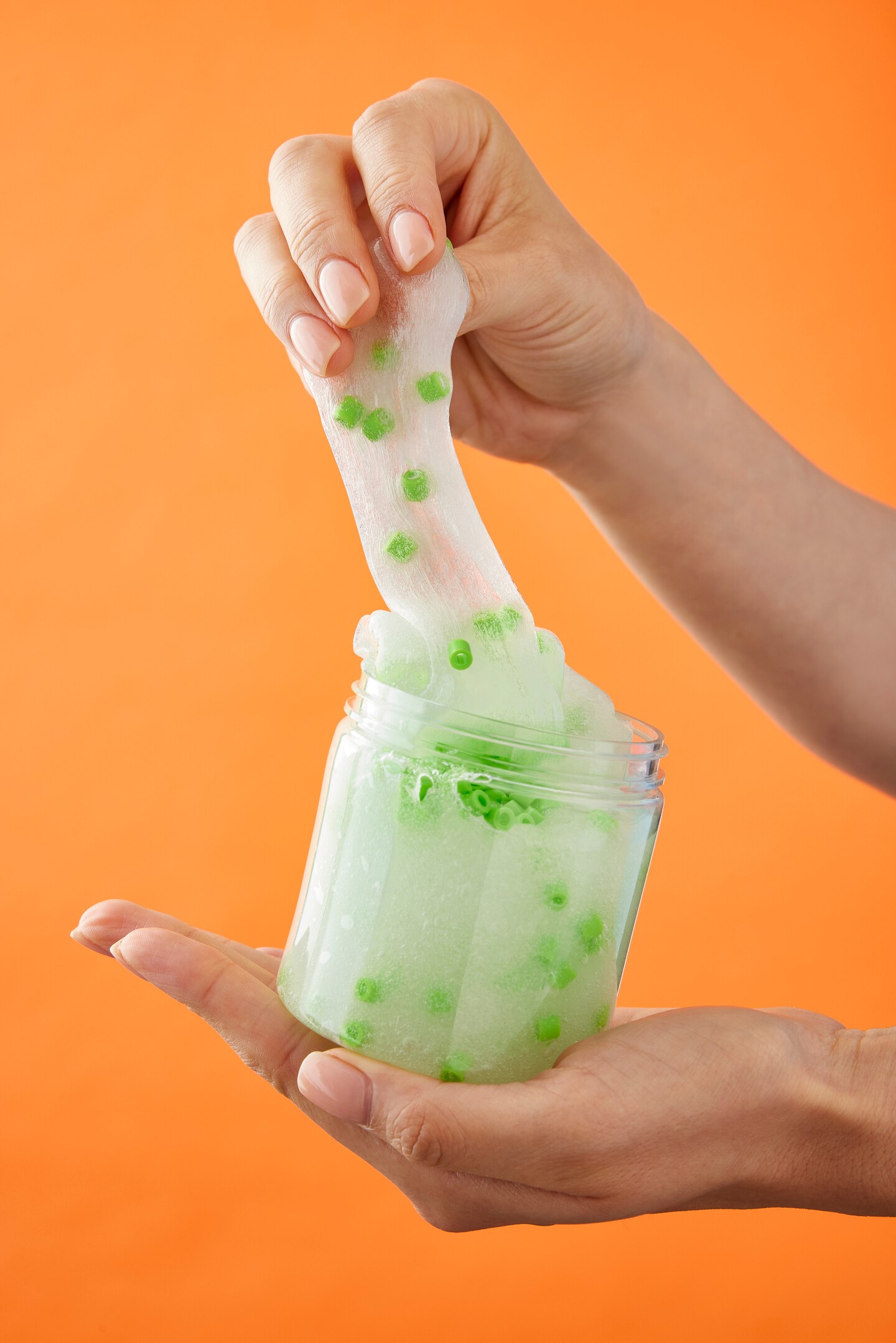 Slime in a jar over an orange background