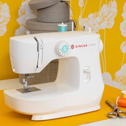 Singer Sewing machine on table with sewing supplies 