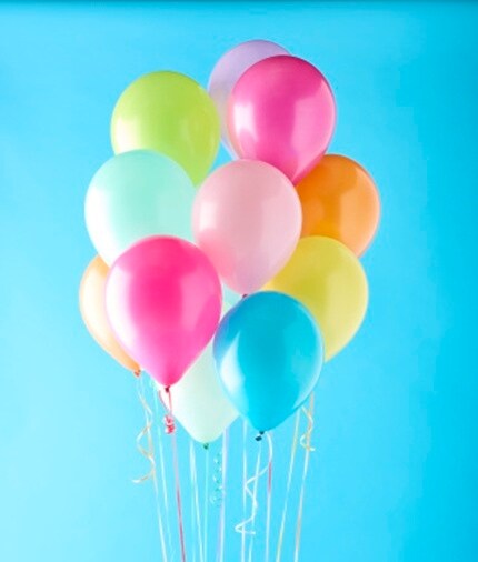 brightly colored latex balloons with blue background