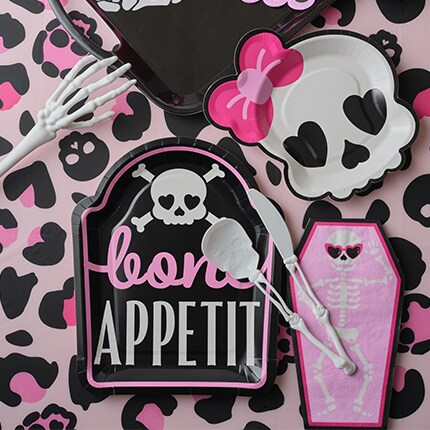 Halloween Party table linen with a ghost and skeleton pattern with a black background.