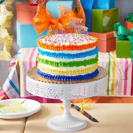 colorful cake on white cake stand 