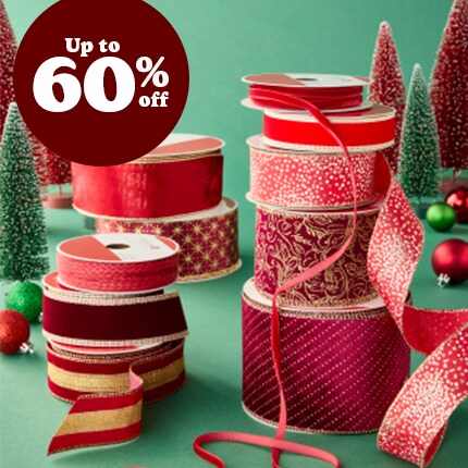 stacked spools of red decorative ribbon with 75 % off in white text over red triangle