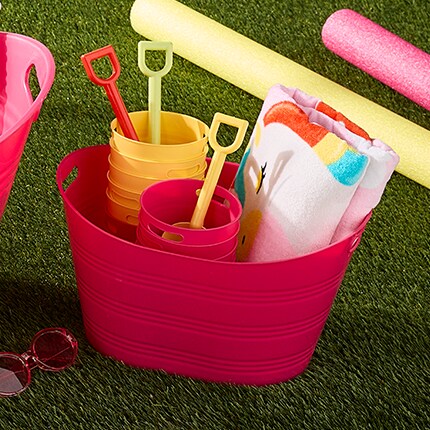 Sand and water toys in a pink bucket