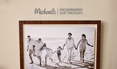 A family vacation frame hanging on a wall.