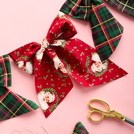 Christmas Fabric with Santa and Christmas Trees on a table with thread