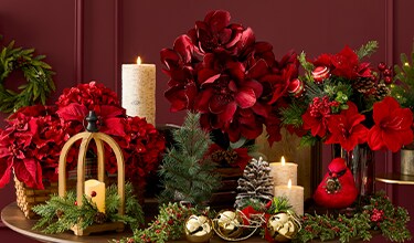 A group of red flowers and candles.