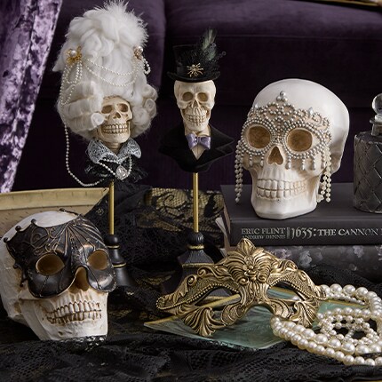 Skulls with masquerade masks on and top hats