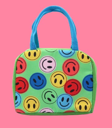 Multi-colored smiley face lunch box with green background and blue handles. 