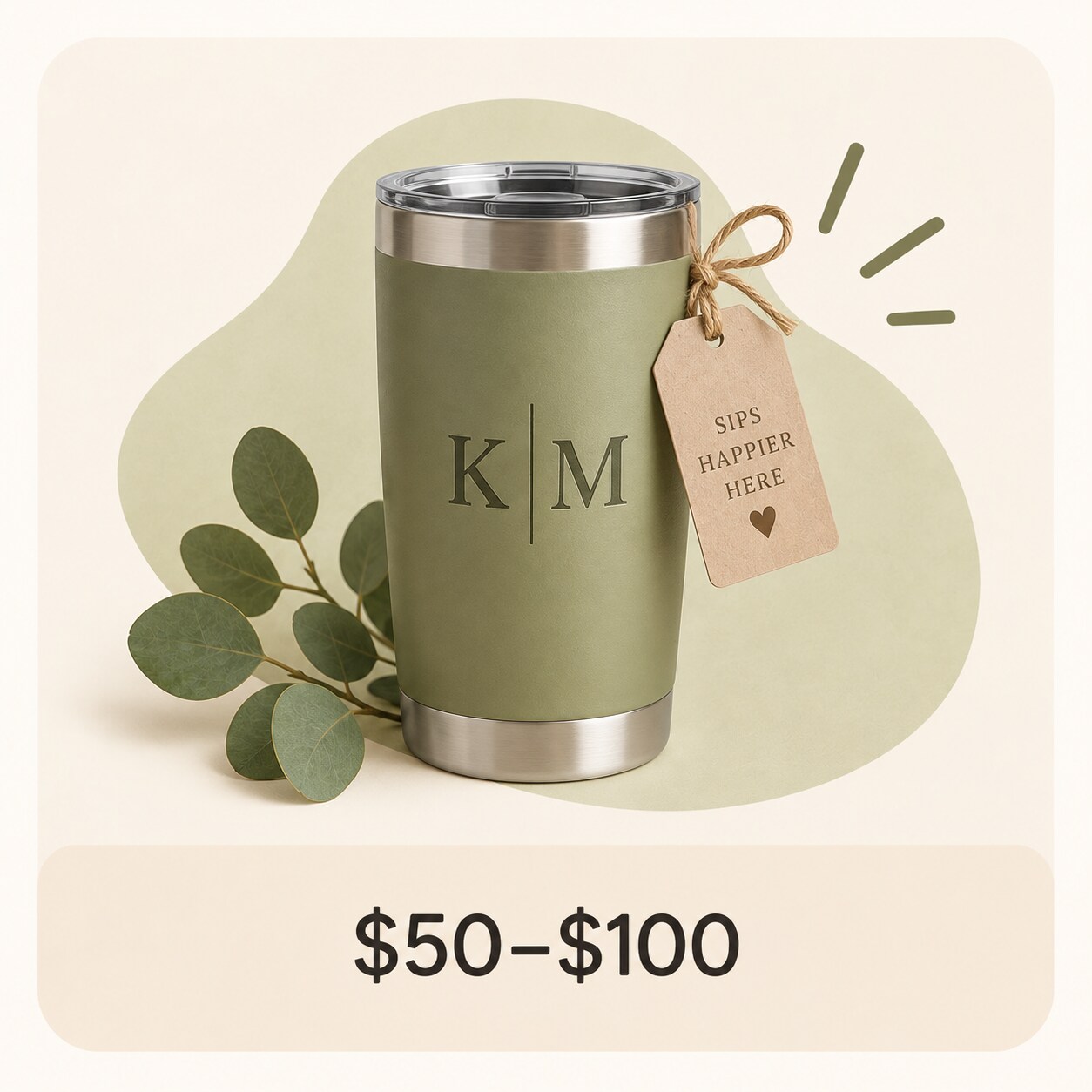 MakerPlace by Michaels Olive green insulated travel tumbler with stainless-steel rim and base, monogrammed “K|M,” doodled shine lines and heart; priced $50–$100.