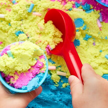 Pink, blue, yellow sensory sand with sprinkles.