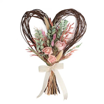  Heart-shaped wreath made from intertwined brown twigs, decorated with pink roses, green leaves, and various dried flowers in pink and beige tones.