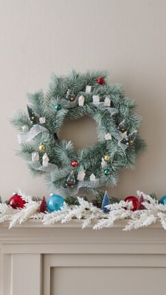 wreath and winter garland on tan wall