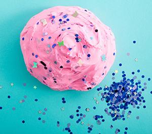 Sequins on a lump of slime on a blue background