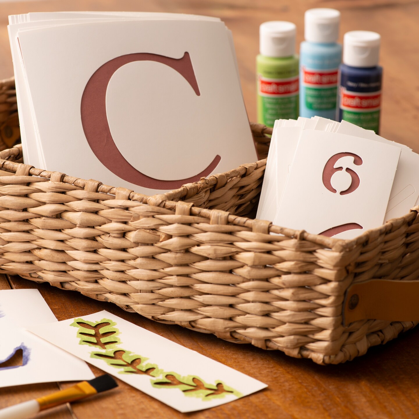 Stencils in wicker basket with craft paint 