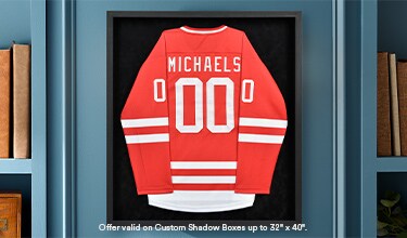 A jersey inside a shadow box on a shelf.