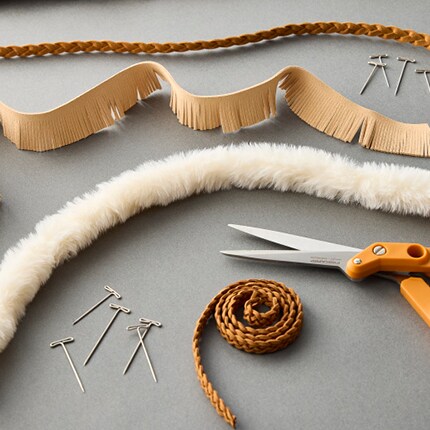 leather and fur trims with scissors and pins
