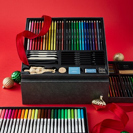 Black and gold gift box with art supplies