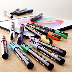 Various paint pens on table